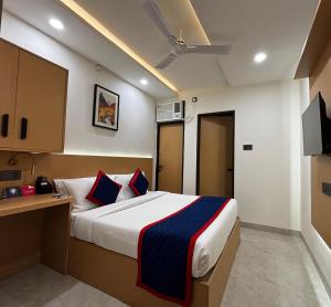 a bedroom with a bed and a desk and a television at Zip By Spree Hotels R Group in Kota