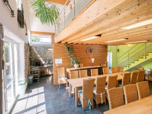 a dining room with a wooden table and chairs at Moderscheid Cottage with Spa in Amblève