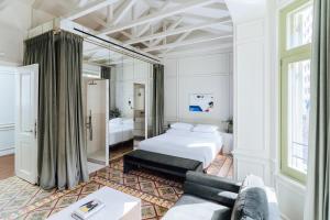 a hotel room with a bed and a couch at Nosteo in Athens