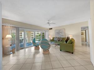 a living room with a couch and chairs and a table at Jamaica Royale in Sarasota