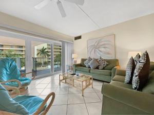 a living room with two couches and a table at Jamaica Royale in Sarasota +32 photos