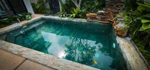 a swimming pool with blue water in a yard at Villa Arcadia in Los Baños