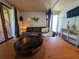 a living room with a large bowl on a wooden table at Les Chalets de Mel in Saint-Lary-Soulan