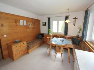 a living room with a table and a couch at Cozy apartment in Außervillgraten in Außervillgraten +16 photos
