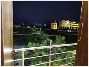 a view of a city at night from a window at Near Sea Beach HOTEL SEA QUEEN RESORT INN ! Puri,Near Jagannath Temple- Fully Air conditioned Rooms ,Wifi and Restaurant, Parking Facilities - A Top Rated Hotel IN PURI in Puri +6 photos