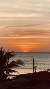 a sunset over the ocean with a bench on the beach at Kua's Pad Batangas Tent in Calatagan +25 photos