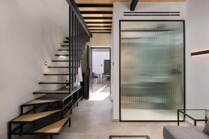 a staircase in a house with black stairs and benches at Agkyra Boutique Hotel in Rhodes Town
