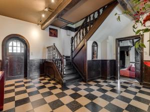 a living room with a staircase and a checkerboard floor at Group Stay with Spa in Vielsalm in Vielsalm