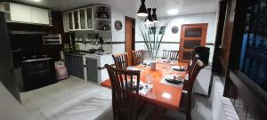 a kitchen with an orange table and chairs in it at Casa há 300m do PARQUE DA CIDADE - COP 30 in Belém