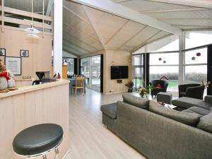 a living room with two couches and a bar at 9 person holiday home in Gørlev-By Traum in Venemose +29 photos