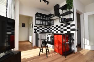 a living room with a checkered wall at Monkey Loft - Graz City Center & Free Garage Parking in Graz