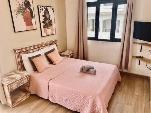 a bedroom with a bed with a stuffed animal on it at Sam & Chlo Studio & Appartment - Grand Baie - Mauritius in Grand-Baie