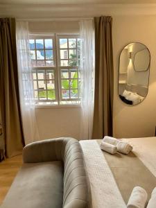 a bedroom with a bed with a mirror and a window at Art déco in Santa Cruz de la Palma +9 photos