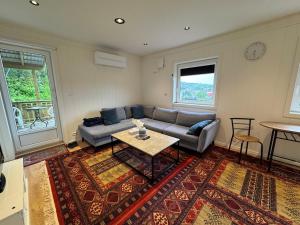a living room with a couch and a table at Modern apartment in Drammen