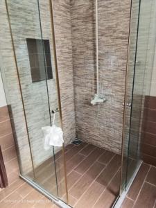 a shower with a glass door with a tissue at Tribal house in Karachi