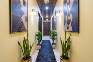 a corridor with potted plants in a hallway at FabHotel Bala Residency in Mumbai