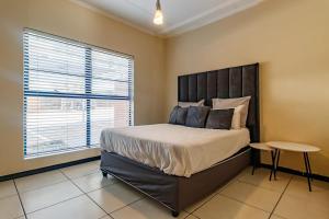 a bedroom with a large bed and a window at Modern 3-Bed Apartment Perfect for Family & Groups in Vosburg