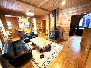 a living room with a couch and a stove at Furano Private Villa Runway 15 in Wada
