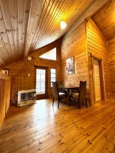 a dining room with a table and chairs in a cabin at Furano Private Villa Runway 15 in Wada