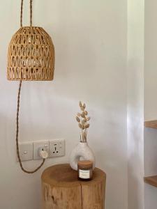 a table with a lamp and a vase on it at Kanferri Villa in Ahangama