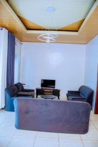 a living room with a couch and a ceiling at BINKS appartement in Kigali