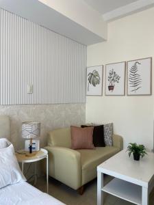 a living room with a couch and a bed at Kasara Pasig Staycation in Manila