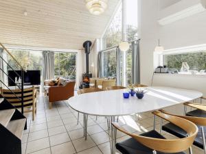 a living room with a white table and chairs at 10 person holiday home in Væggerløse-By Traum in Marielyst