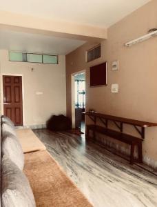 a living room with a couch and a tv at Backpackers Bunkhouse Siliguri 8Bed WHY WAIT in Siliguri +38 photos