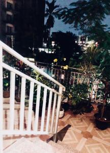 a white railing on a staircase with plants at Backpackers Bunkhouse Siliguri 8Bed WHY WAIT in Siliguri