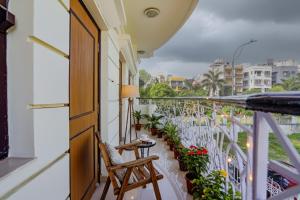 a balcony with a table and chairs and plants at FabHotel New kolkata Residency Inn - Nr Axis Mall in Kolkata