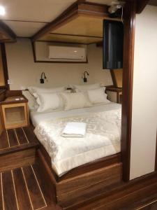 a bedroom with a bed with a tv on it at Trebenna in Omiš