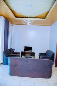 a living room with a couch and a ceiling at BINKS appartement in Kigali