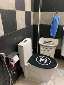 a bathroom with a toilet with a logo on it at Studio du Bonheur Mer et Nature Rawai beach in Nai Harn Beach +7 photos