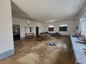 a living room with a table in the middle of it at Hiliki private house in Umbuji