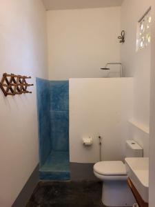 a bathroom with a toilet and a sink at Hiliki private house in Umbuji