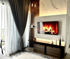 a living room with a fireplace in the wall at ANNA AR ANTARA RESIDENCE LAKE VIEW, Putrajaya in Putrajaya