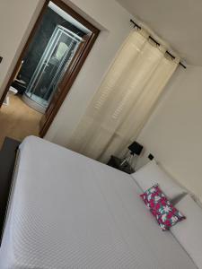 a bedroom with a white bed and a window at Girasole Casa Vacanza in Stradella