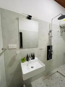 a bathroom with a white sink and a mirror at Erene Inn in Ella +47 photos