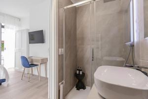 a bathroom with a shower and a sink and a toilet at Marty Suites - Luxury Rooms in Pescara +49 photos