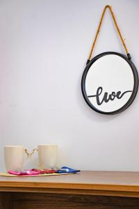 a mirror hanging on a wall next to two cups at Centrino in Burgas