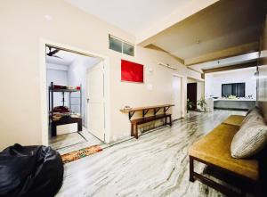 a living room with a couch and a table at Backpackers Bunkhouse Siliguri 8Bed WHY WAIT in Siliguri