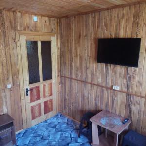 a corner of a room with a television on a wall at Villa Gold in Yaremche