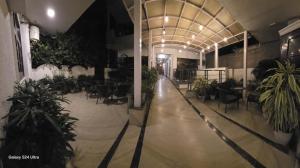 a hallway with chairs and plants in a building at The Maple Stays in Gurgaon