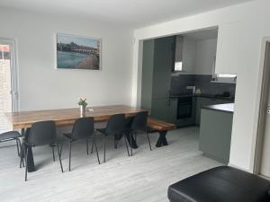 a kitchen and dining room with a wooden table and chairs at Holiday Home Prague Šeberov in Prague
