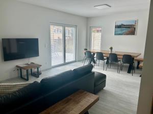 a living room with a couch and a table with chairs at Holiday Home Prague Šeberov in Prague