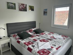 a bed with a quilt on it in a bedroom at Holiday Home Prague Šeberov in Prague