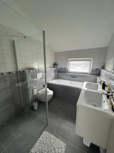 a bathroom with a tub and a toilet and a sink at Holiday Home Prague Šeberov in Prague +35 photos