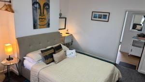 a bedroom with a bed and a painting on the wall at SOBO Studio in Bournemouth