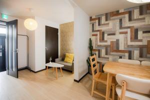 a living room with a table and a couch at Rakuyodo Higahikujo in Kyoto