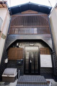 a staircase leading to a building with a door at Rakuyodo Higahikujo in Kyoto